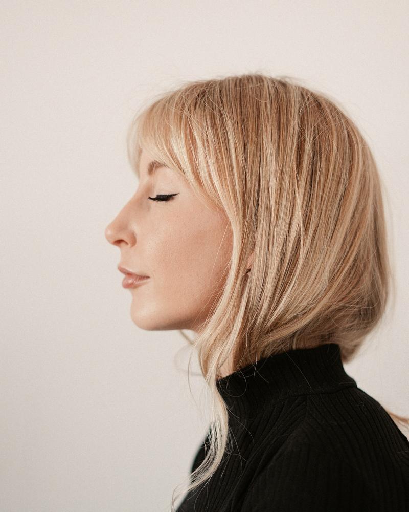A soft blonde bob with a long fringe, seen in profile