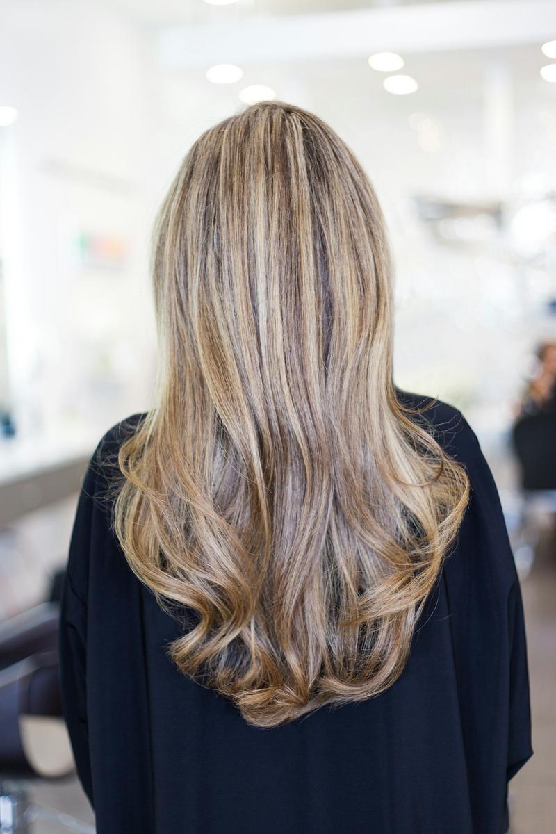Long hair with dimensional blonde highlights, seen from behind
